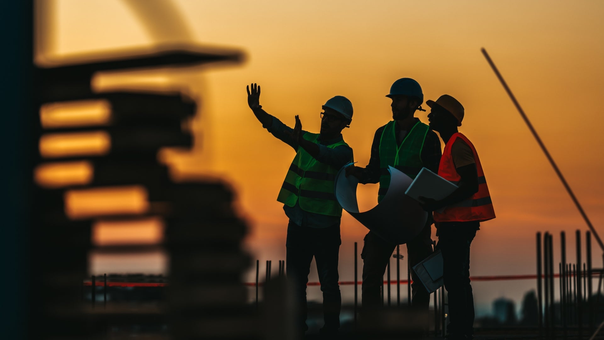 Construction workers talking during the sunset