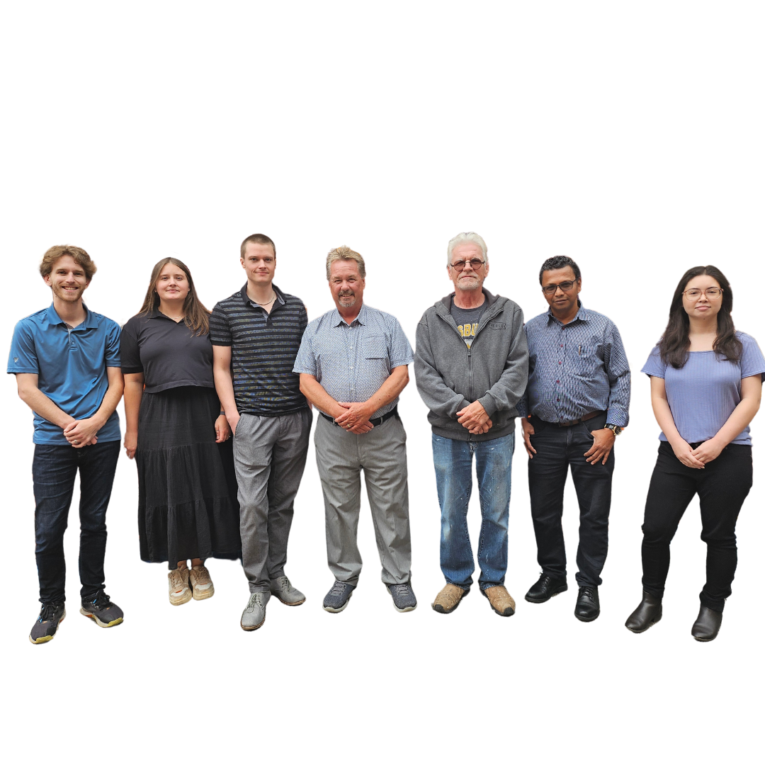 A group photo of all company employees standing together, smiling, and posing for the camera. 